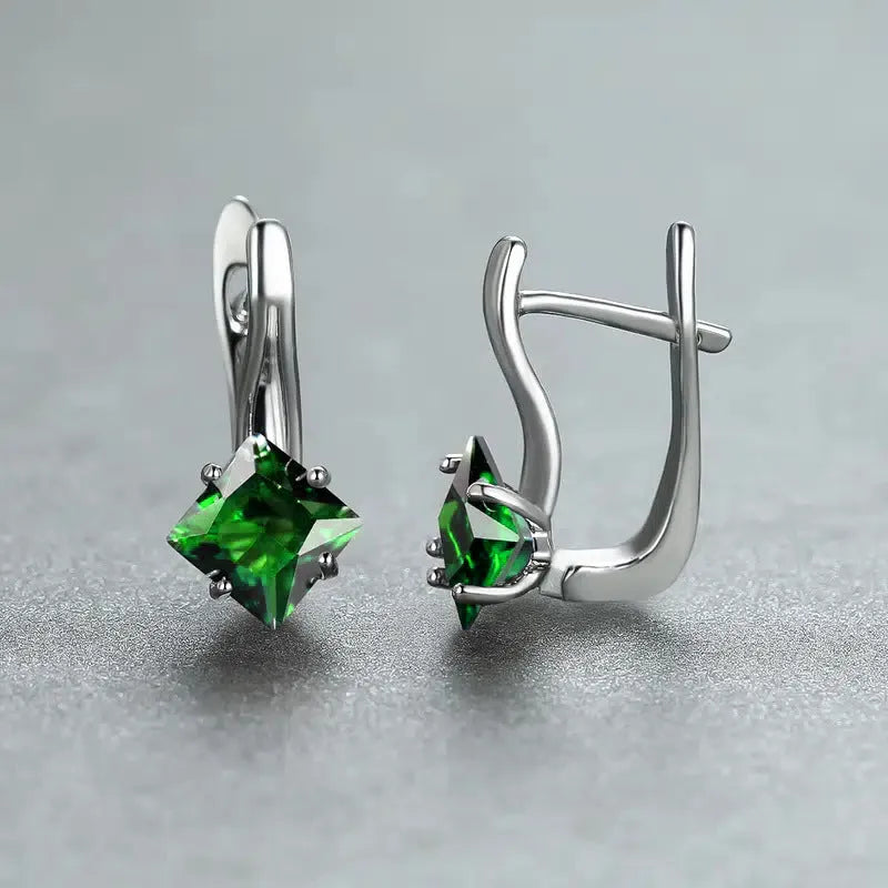 A pair of women's diamond-shaped copper earrings with inlaid zircon stones, shown in a blue colour variant.