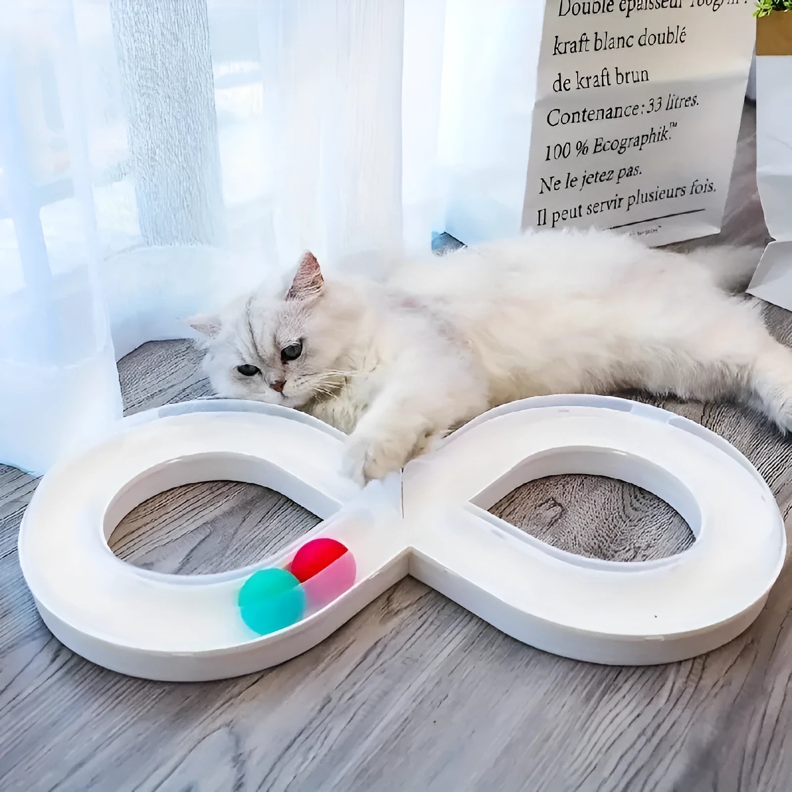 Blue and white cat interactive toy with turntable track ball and teasing stick on flat surface