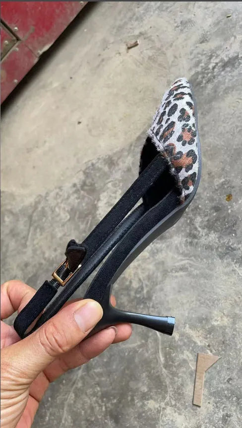 Leopard print suede women's sandals with a pointed toe and high heel.