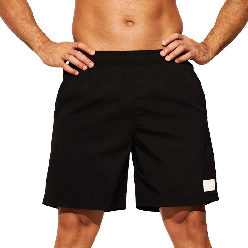 Men's solid colour quick-drying nylon sports shorts on a hanger, showing straight leg design