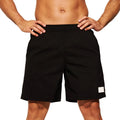 Men's solid colour quick-drying nylon sports shorts on a hanger, showing straight leg design