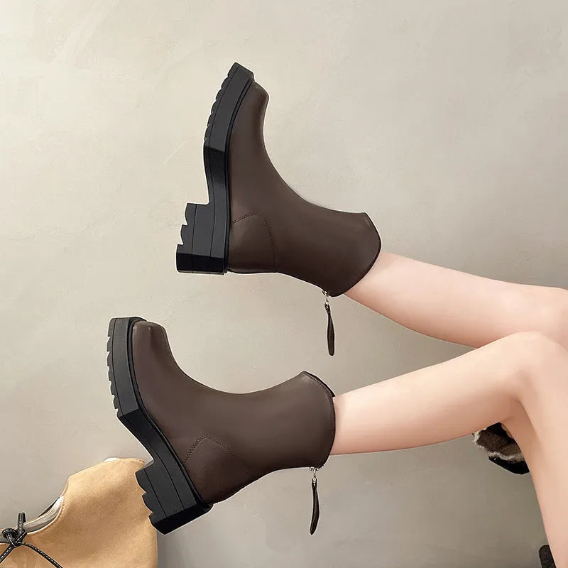 Black platform Martin boots for women with square toe and back zipper on a mid-calf.