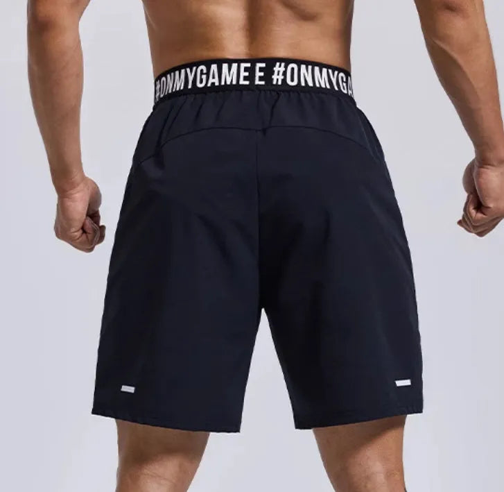 Men's loose black sports cropped shorts with elastic waistband and printed letter detailing