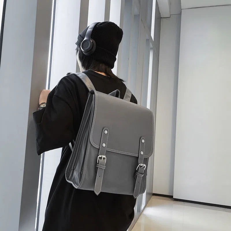PU leather motorcycle-style buckle laptop backpack with geometric pattern in black, gray, and white, 20-35 litres capacity