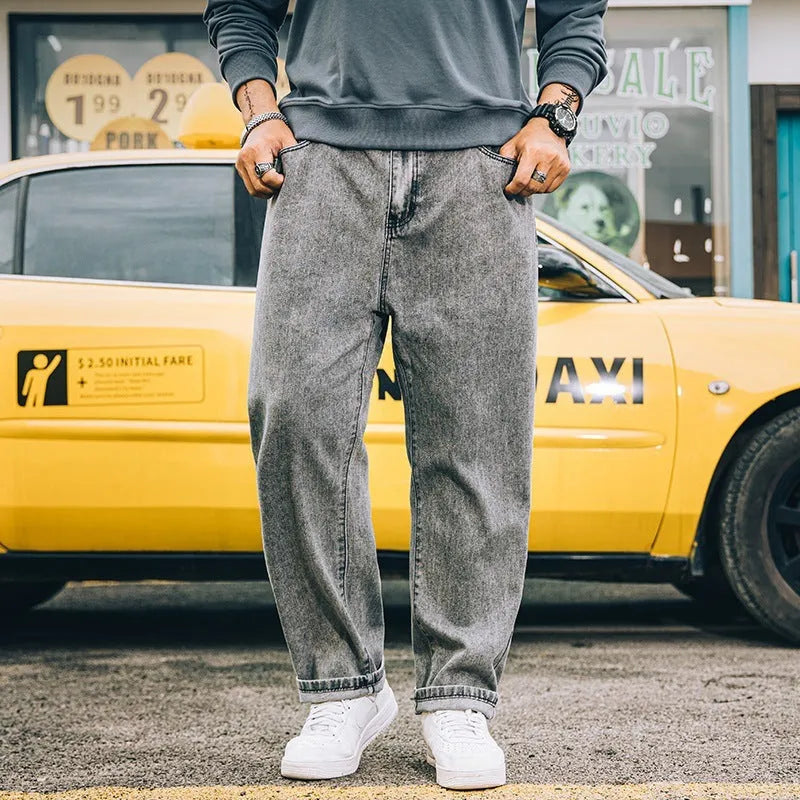 Men's loose straight-leg casual jeans in dark blue cotton on a hanger.
