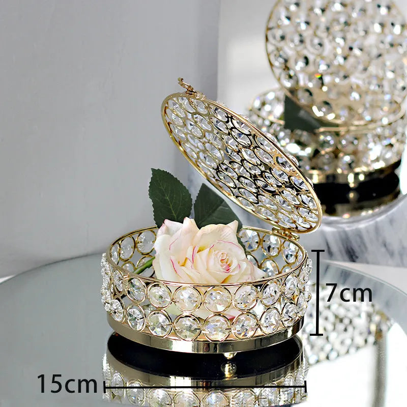 French gold metal jewelry box with a clear crystal glass front panel on display.