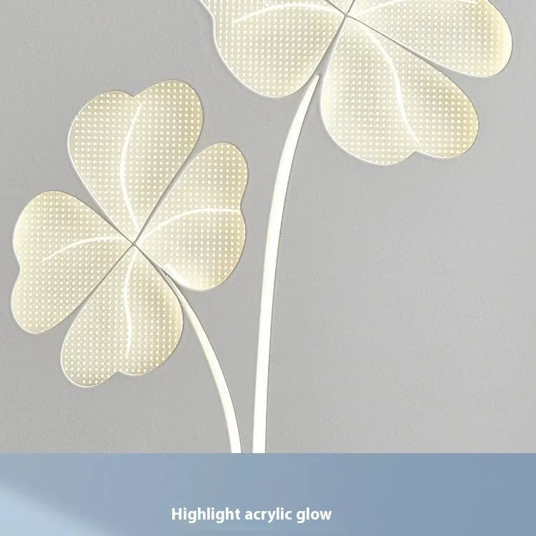 Modern cream coloured bedside lamp with acrylic shade and iron base on a wooden table.