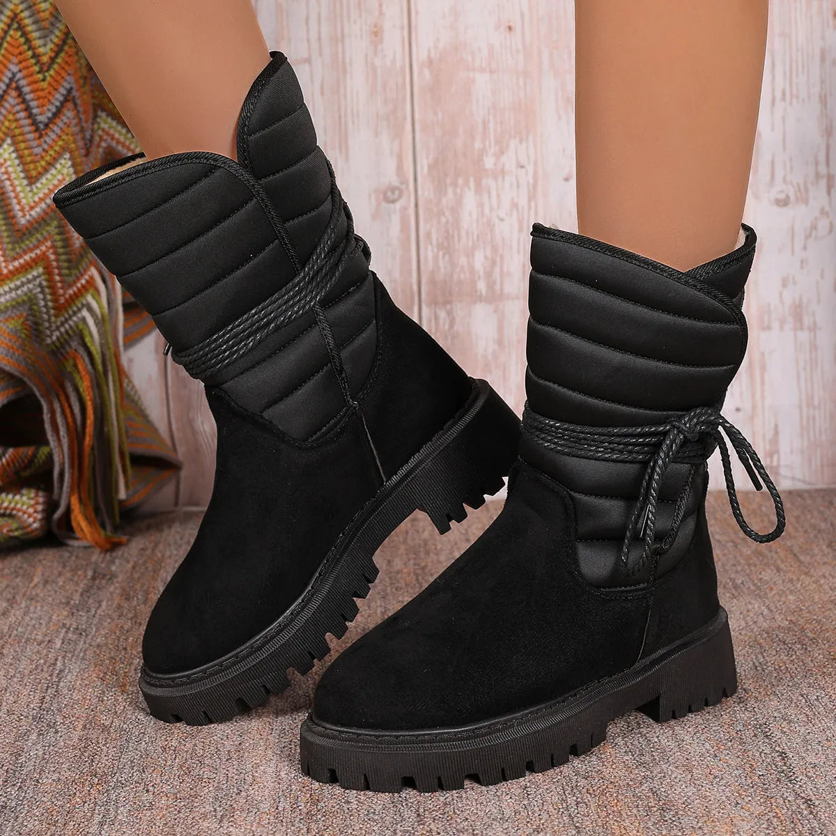 Women's black chunky heel snow boots with suede upper and lace-up design