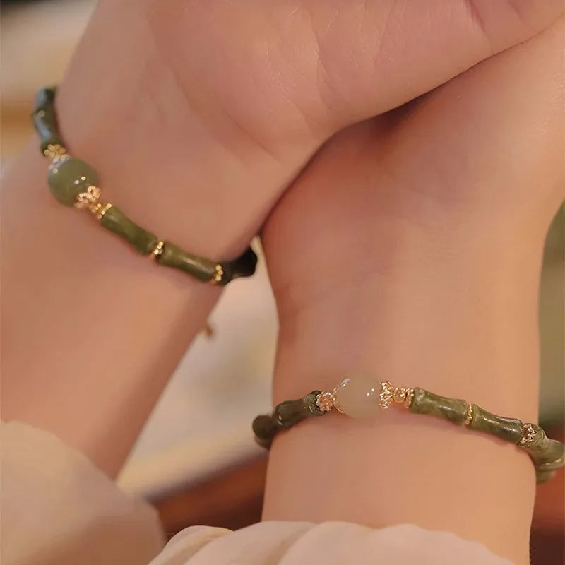 Hetian jade bracelet with geometric shape and round elements on female wrist