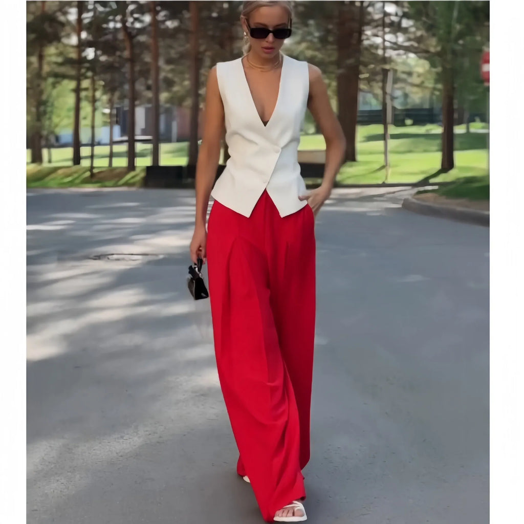 Women's beige two-piece set with deep V-neck sleeveless top and high-waisted wide-leg trousers.
