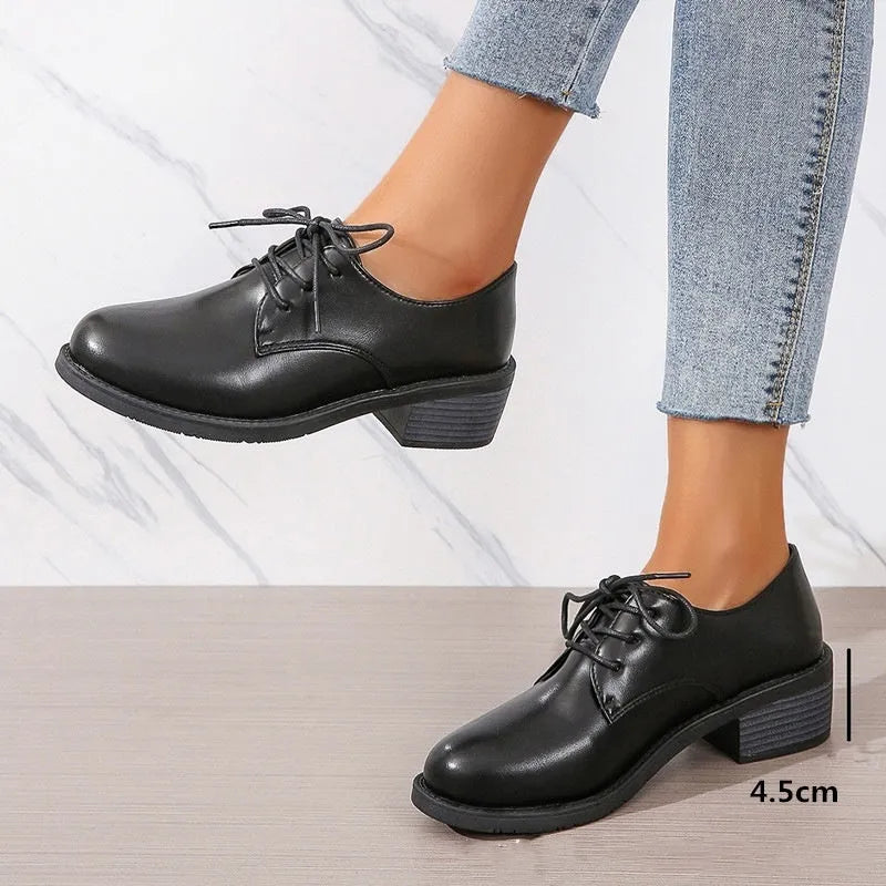 Black women's low-top PU leather shoes with a chunky mid-heel and pointed toe.