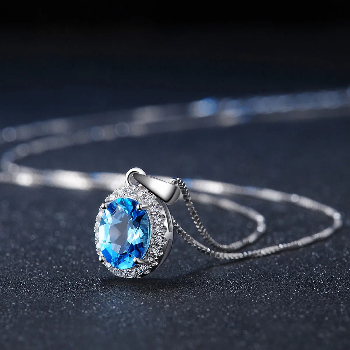 Four-piece sterling silver jewellery set with blue topaz stones including geometric earrings, ring, bracelet and necklace
