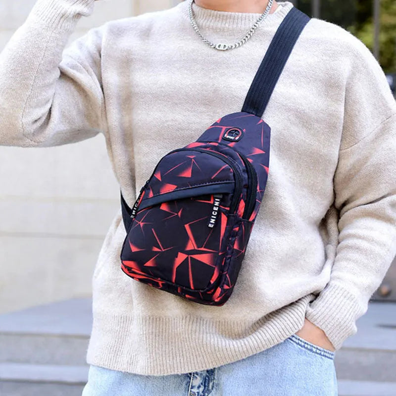 Men's blue print sling chest bag with earphone hole, shown worn crossbody.
