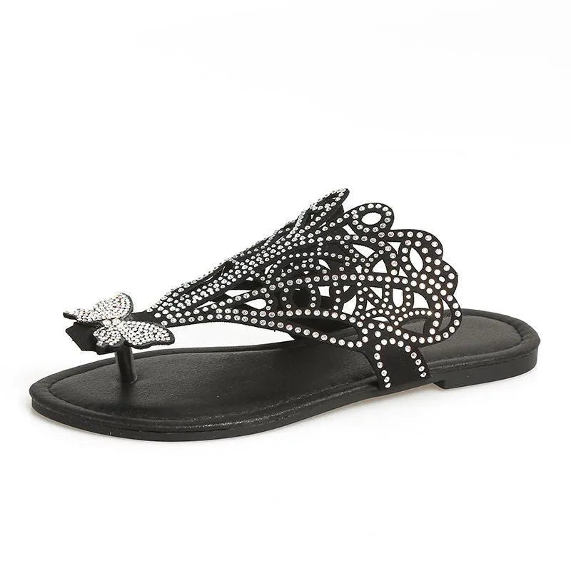 Gold women's flip-toe sandals with hollow-out design and rhinestone decorations on a flat rubber sole.