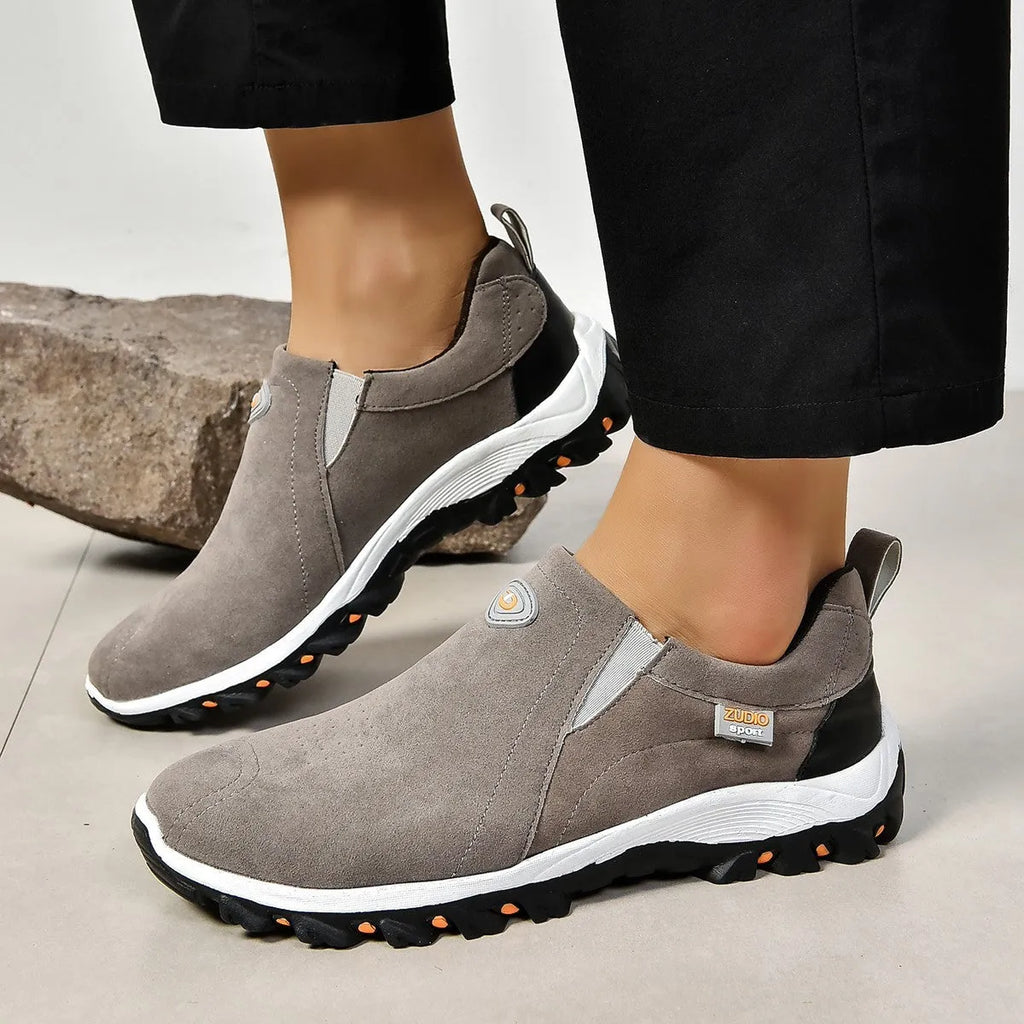Men's gray round toe slip-on casual shoes with a rubber sole on a plain background.