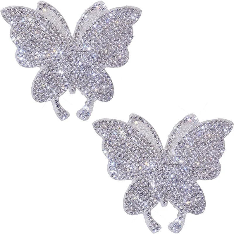 Glass car sticker with diamond detailing in butterfly or bear claw design, 7cm by 6cm.