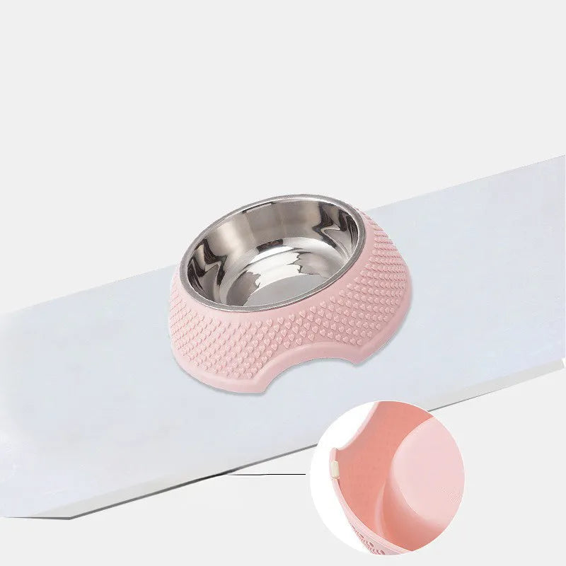 Blue stainless steel pet bowl with non-slip base for cats and dogs on a kitchen floor.