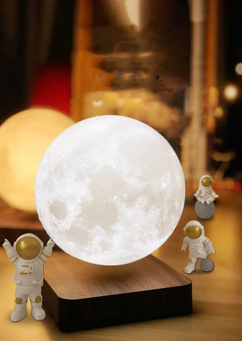 Maglev floating moon planet night light with LED glow and astronaut figures on a table