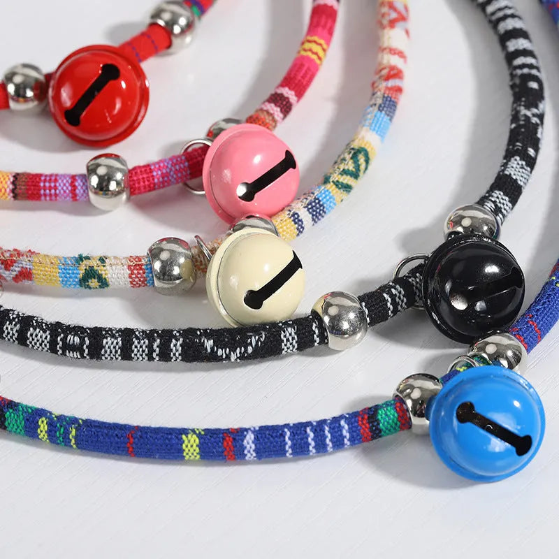 Coloured ethnic-style adjustable pet collar for dogs and cats with a small bell, shown in multiple colour options.