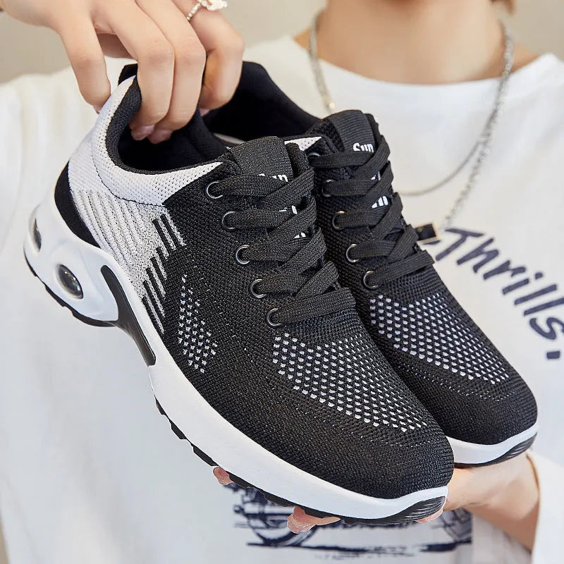 Women's striped Flyknit casual running shoes in pink with a round toe and flat PVC sole.