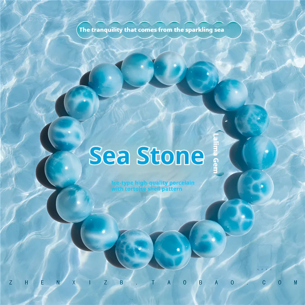 Blue and natural toned bodhi bracelet with a sea-pattern crystal stone centre and pearl accent.