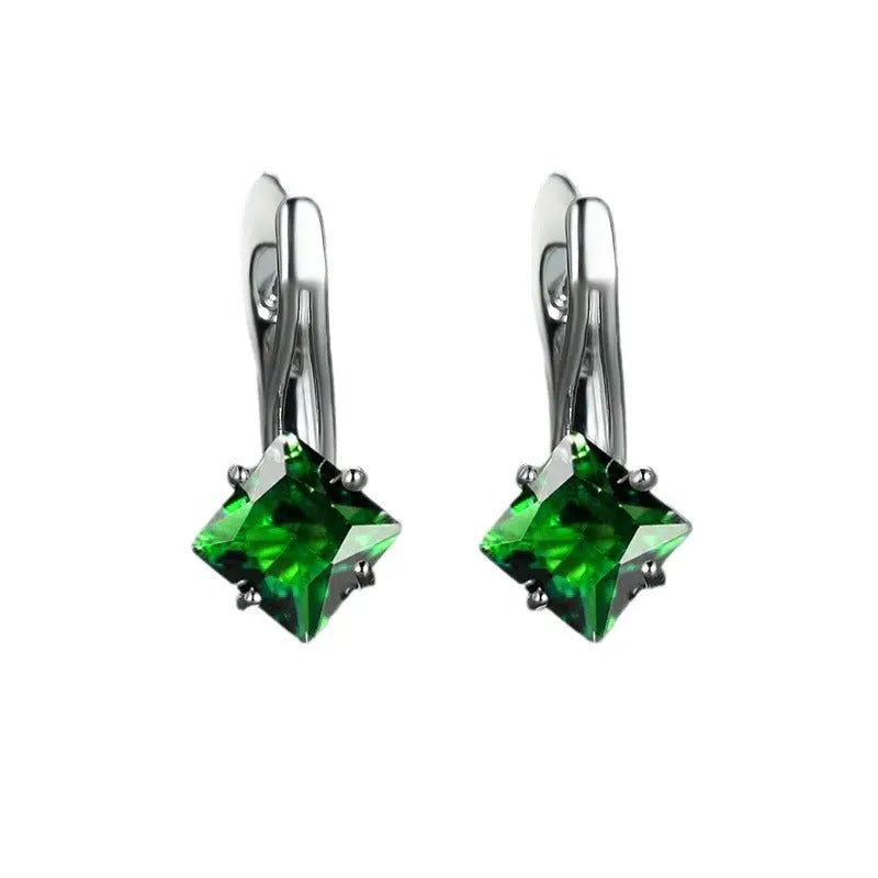 A pair of women's diamond-shaped copper earrings with inlaid zircon stones, shown in a blue colour variant.