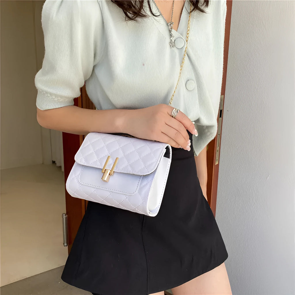 Women's diamond lattice chain crossbody bag in minimalist solid colour design with adjustable strap