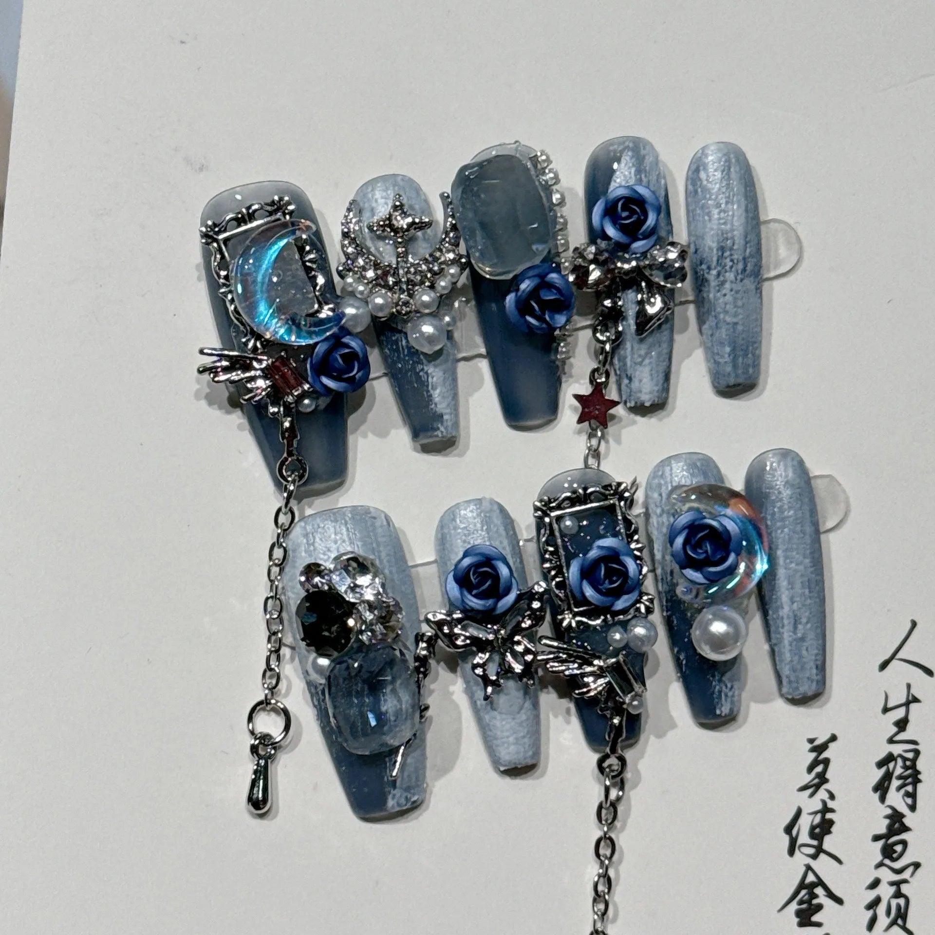 Blue evening manicure set with rose pattern on plastic nail armour suit