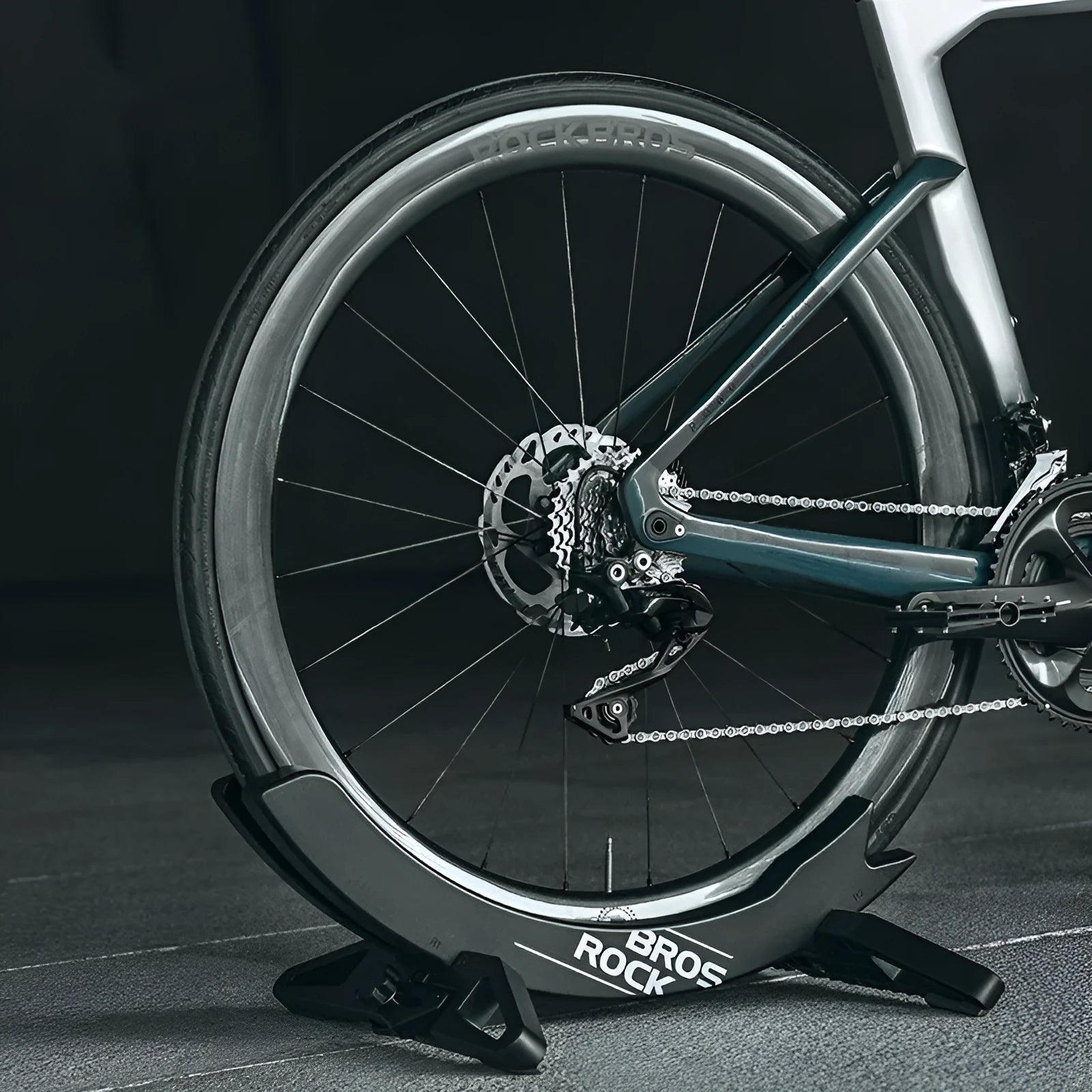 Black and green ABS plastic bicycle parking rack holder with fixed mounting bracket.