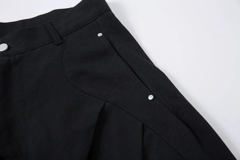 Men's black cotton trousers with pleated machete detailing and loose-fitting wide-leg silhouette
