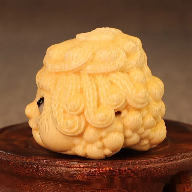 Solid bamboo carved golden toad princess ornament on display.