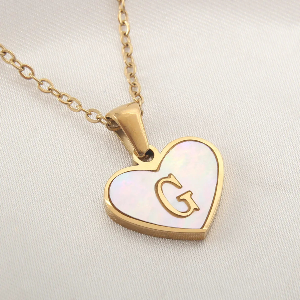 Gold plated heart necklace with white shell detail on an adjustable chain