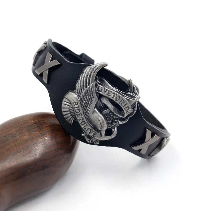 Black leather geometric bracelet with alloy eagle watch-butttom closure, showing varying widths along 26cm length