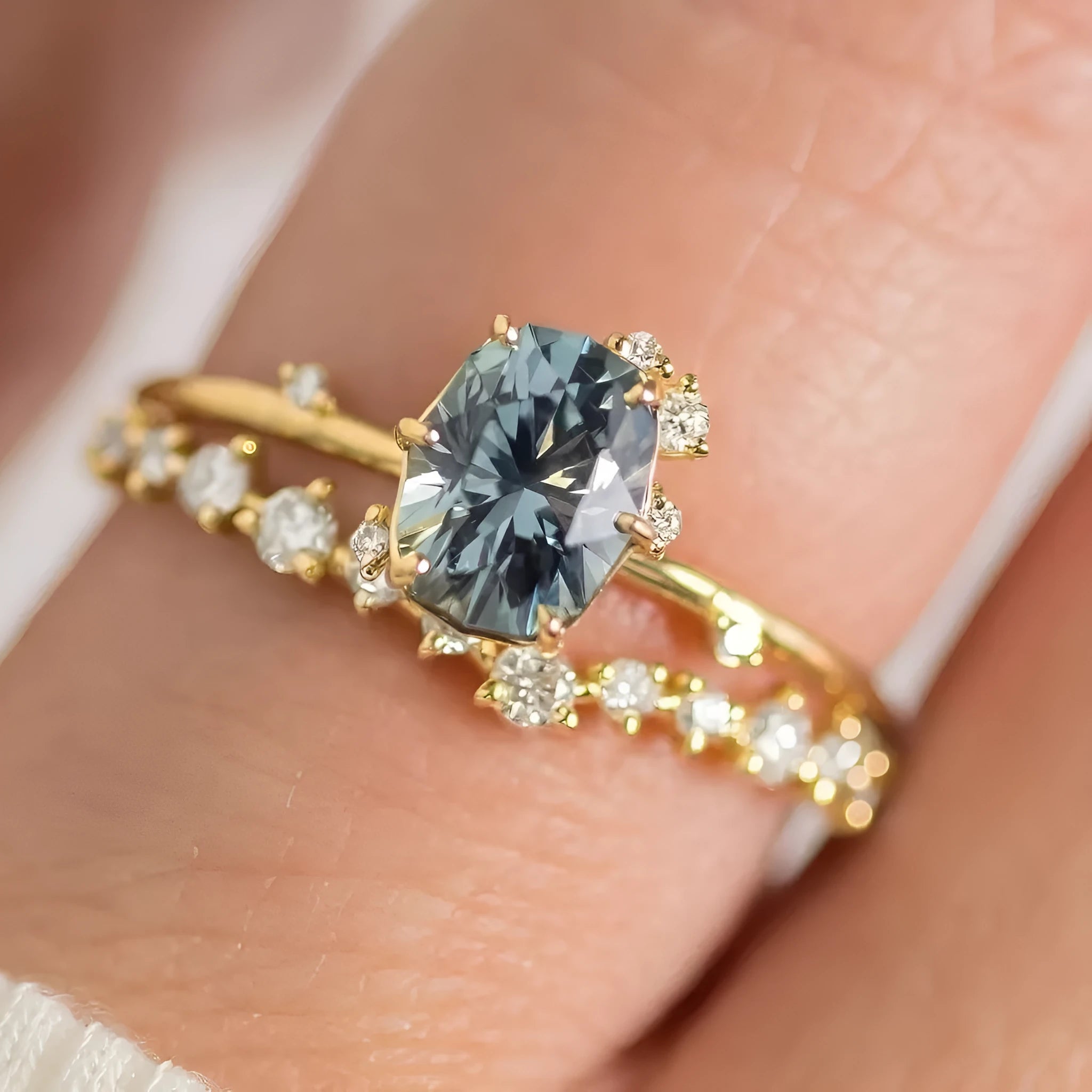 Gold-plated floral fashion ring with a central green zircon stone on a hand.