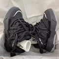 Grey women's chunky lace-up sneakers with a thick rubber sole and retro design on a white background.