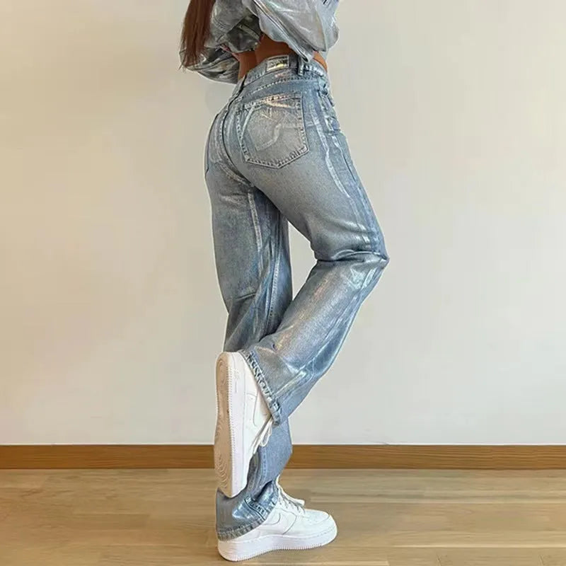 Washed blue high-waist straight-leg jeans with contrast colour detailing on a denim background.