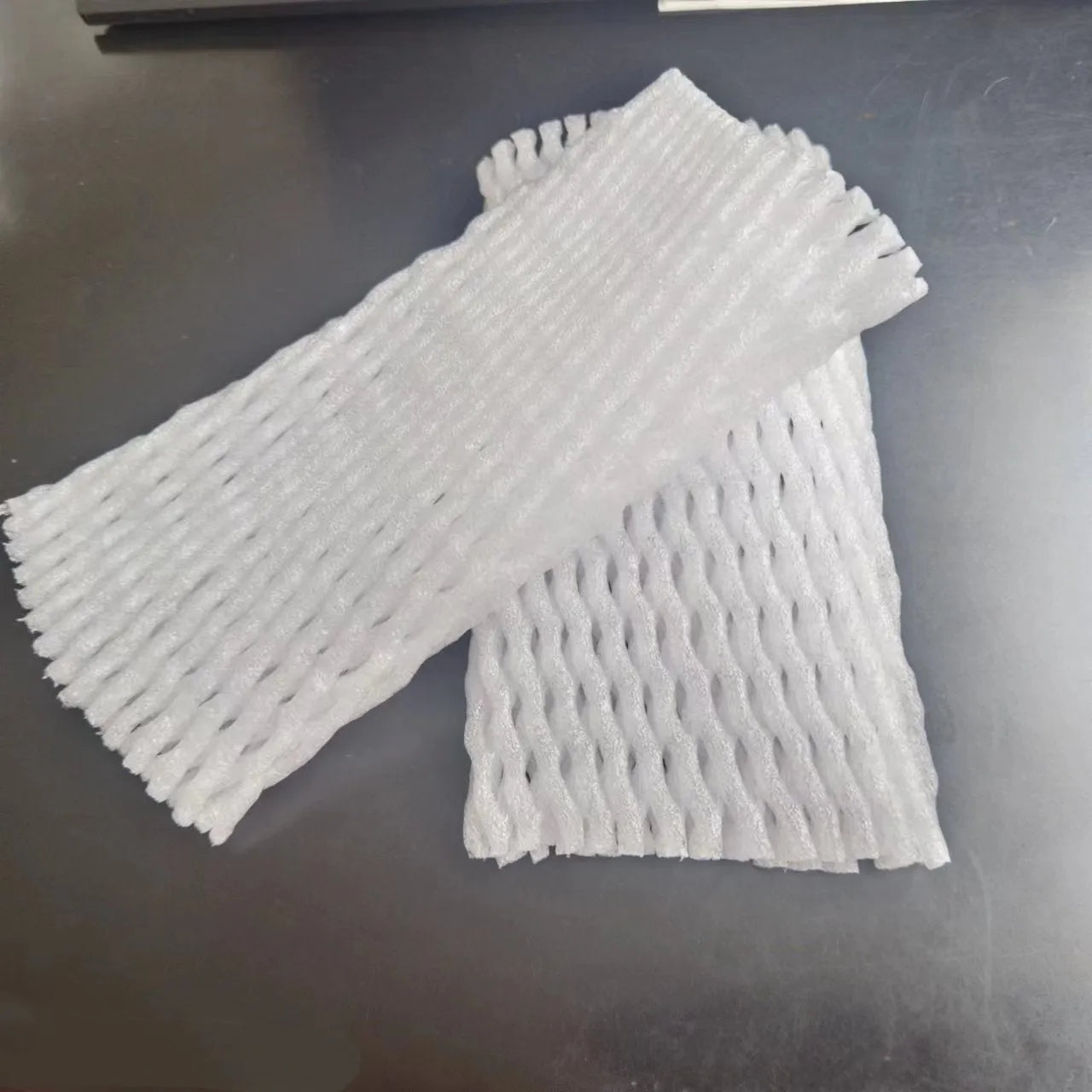 White foam fruit net cover shown in various sizes for protective wrapping.