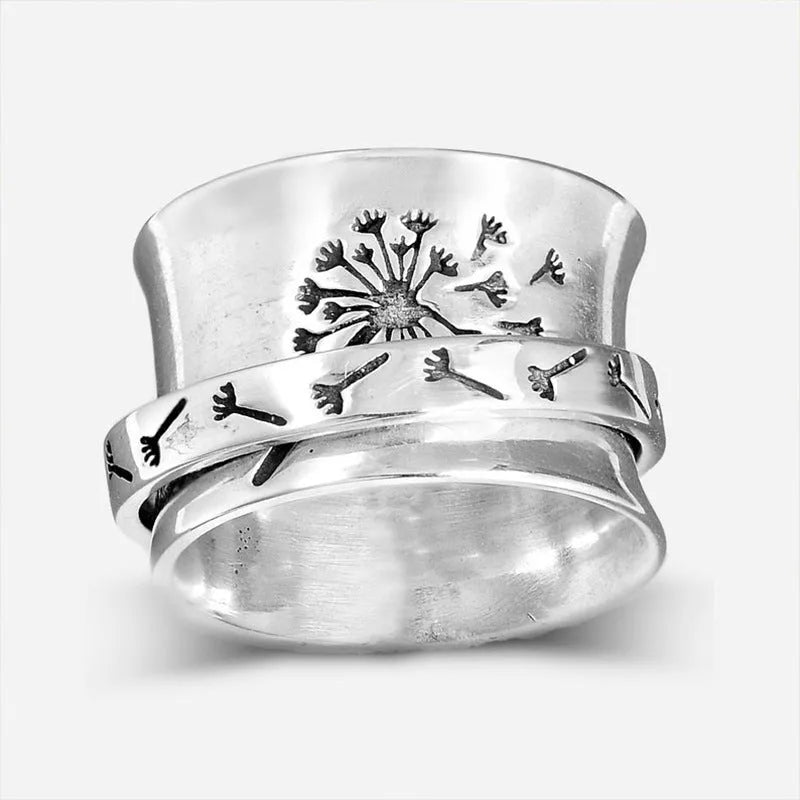 Rotatable silver-colour flower ring showing adjustable design on finger
