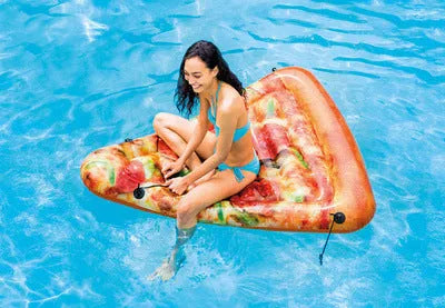 Large red and yellow inflatable pizza slice on a surfboard design, floating on water.