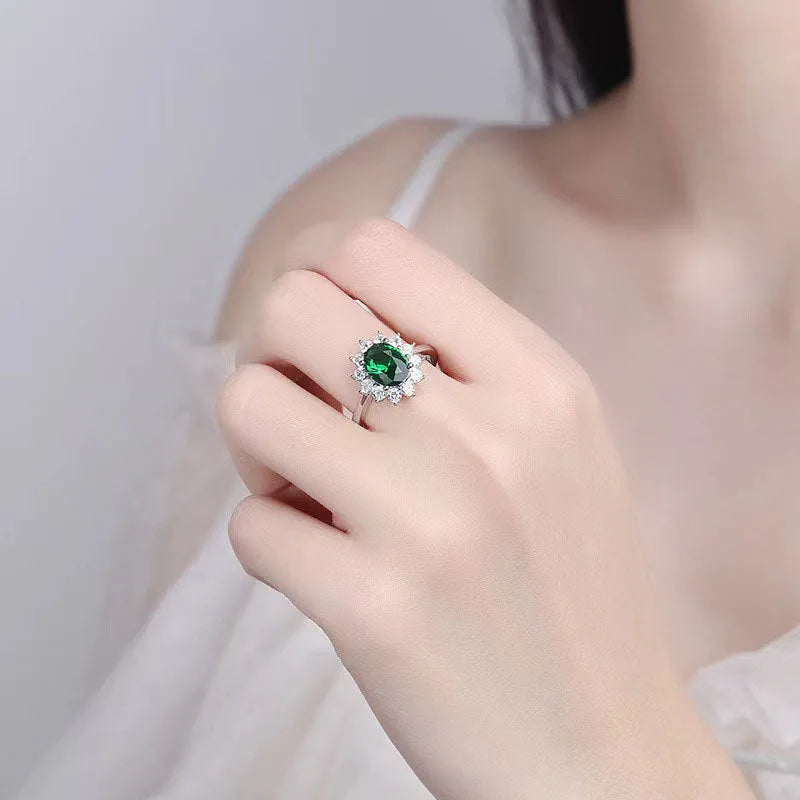 Copper floral women's ring with inlaid blue zirconium stone, shown on a finger against a neutral background.