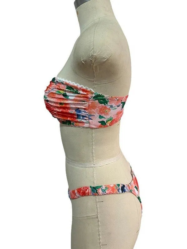 Women's floral print bikini set with lace trim on a tube top and briefs in blue.