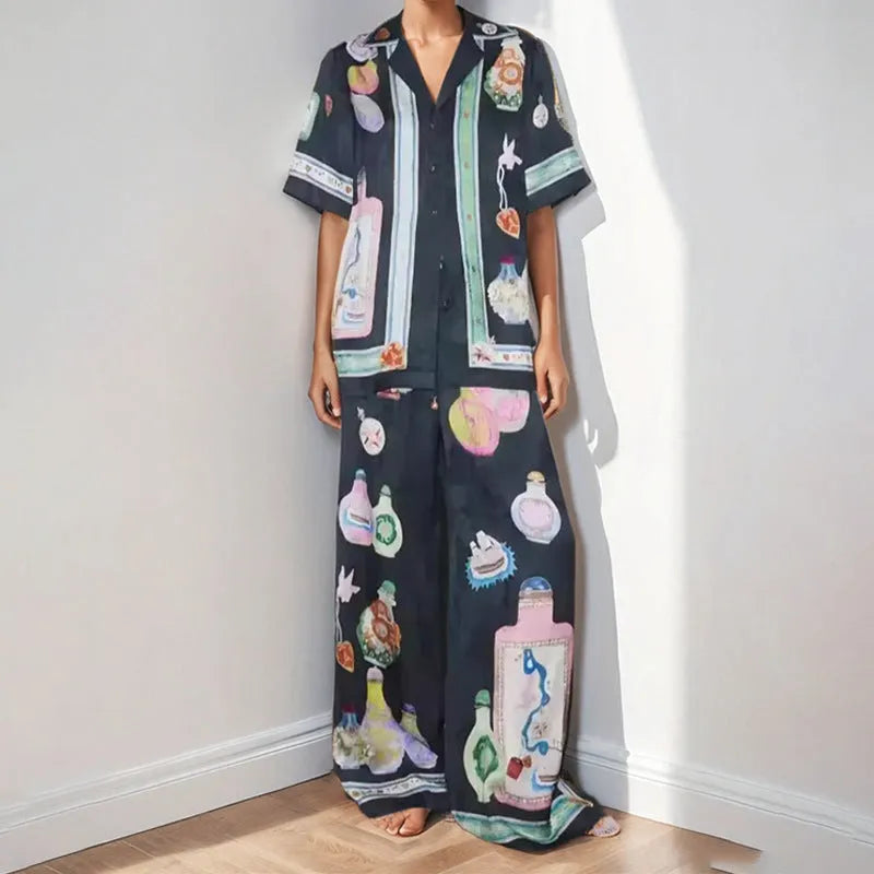 Black women's casual set with cartoon print, featuring sleeveless cardigan and trousers.