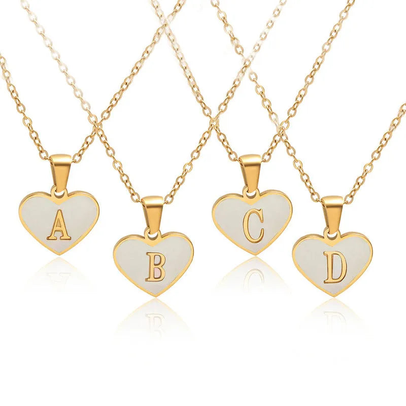 Gold plated heart necklace with white shell detail on an adjustable chain