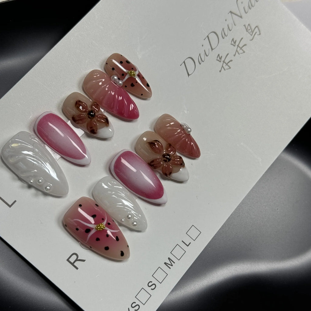 Three-dimensional carved nail art patches with hand-painted designs for almond-shaped nails