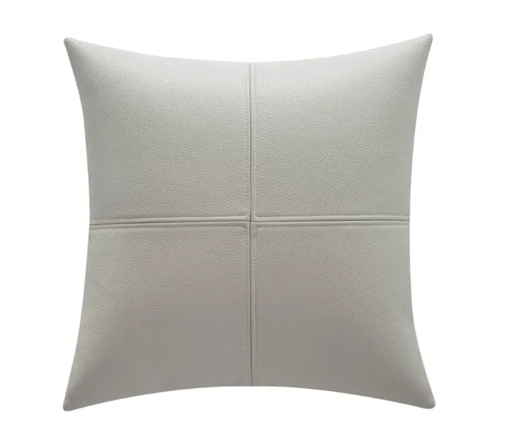 Soft cowhide leather pillow cover in beige white, shown on a grey sofa.