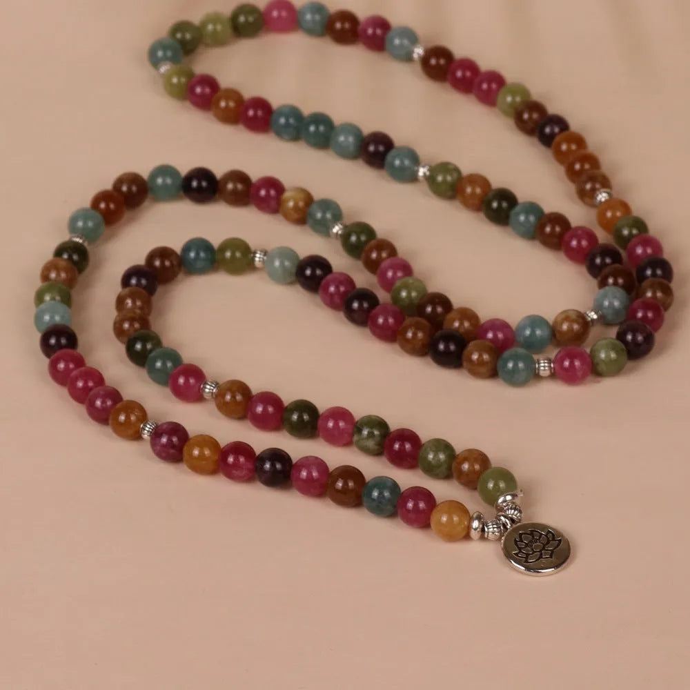 108-bead multi-layer alloy bracelet in a tourmaline colour, shown hanging and as worn jewellery.