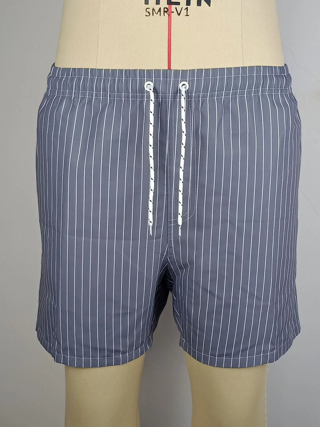 Men's navy blue polyester casual shorts with a visible striped triangle lining inside.