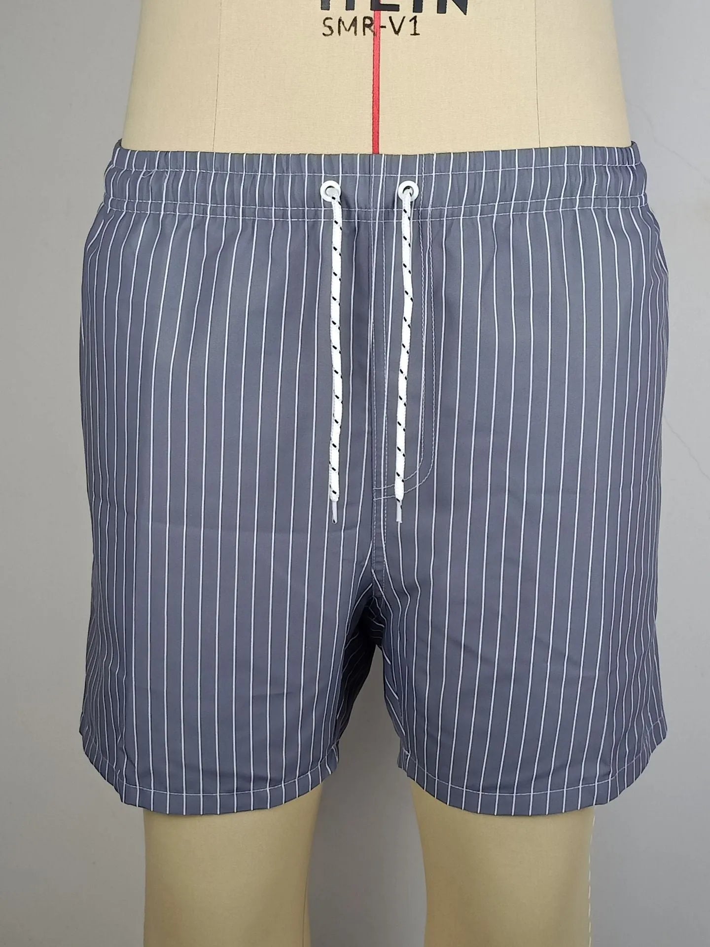 Men's navy blue polyester casual shorts with a visible striped triangle lining inside.