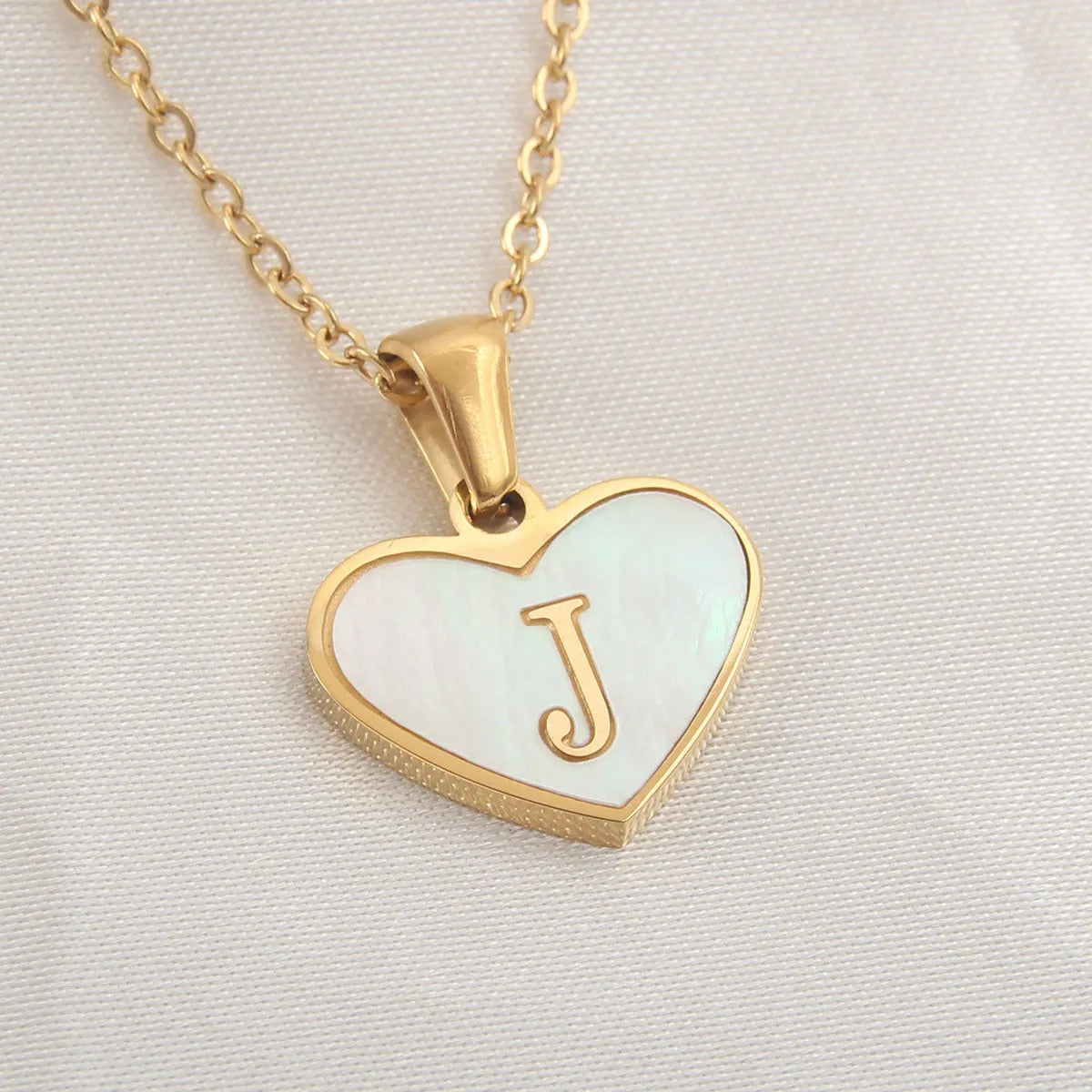 Gold plated heart necklace with white shell detail on an adjustable chain