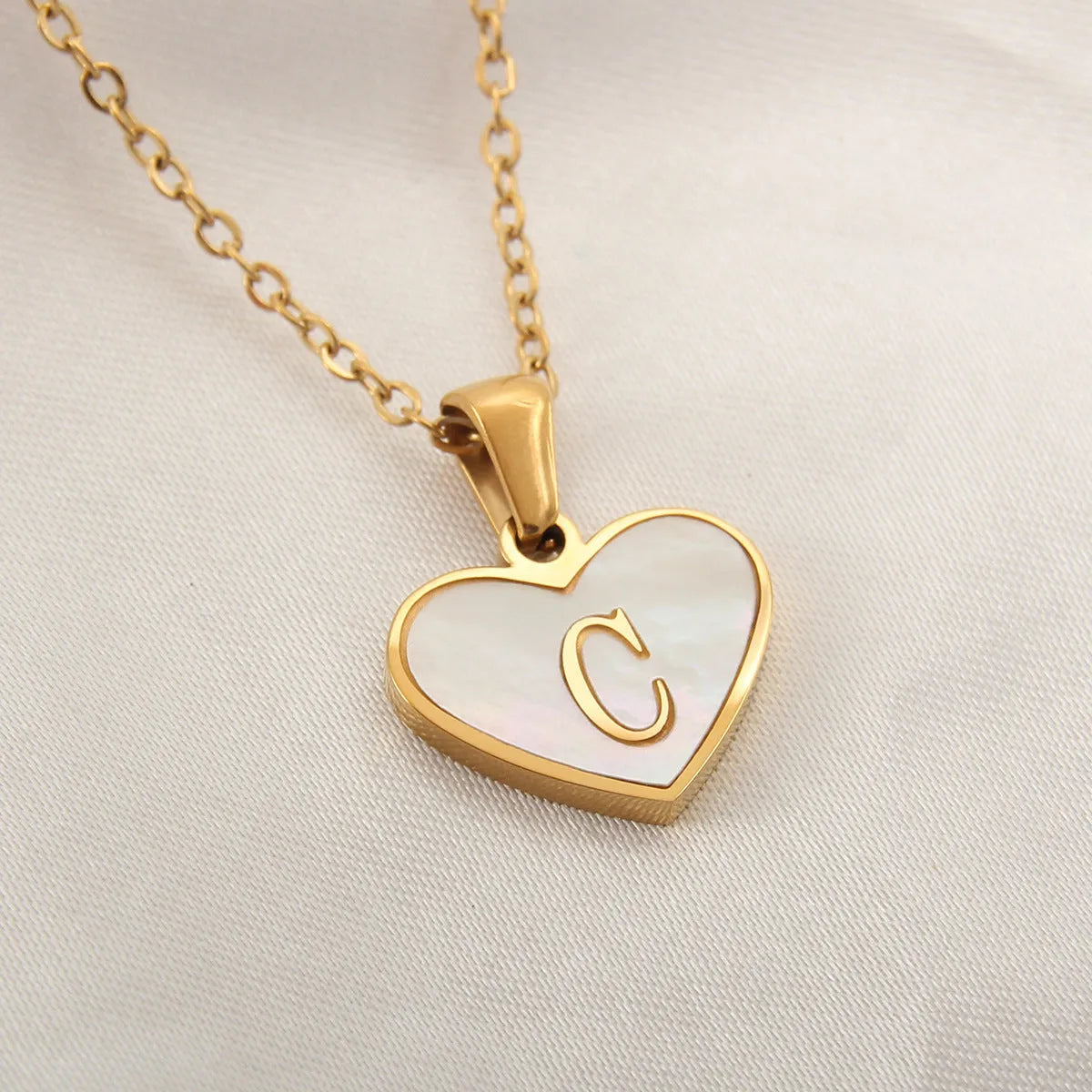 Gold plated heart necklace with white shell detail on an adjustable chain